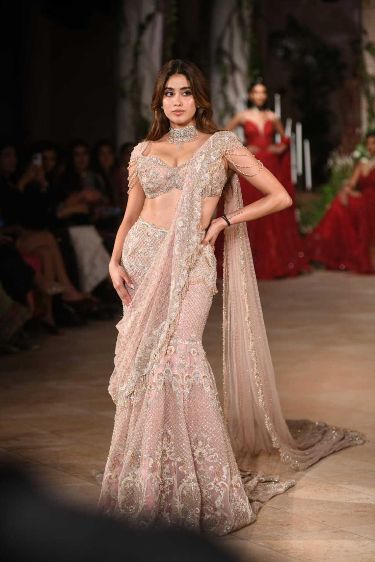 Janhvi Kapoor stunned on the ramp in Jayanti Reddy's pastel embellished lehenga with intricate embroidery and a heavily adorned blouse featuring delicate pearl details. She completed her ethereal look with a choker and opted for dewy makeup. 